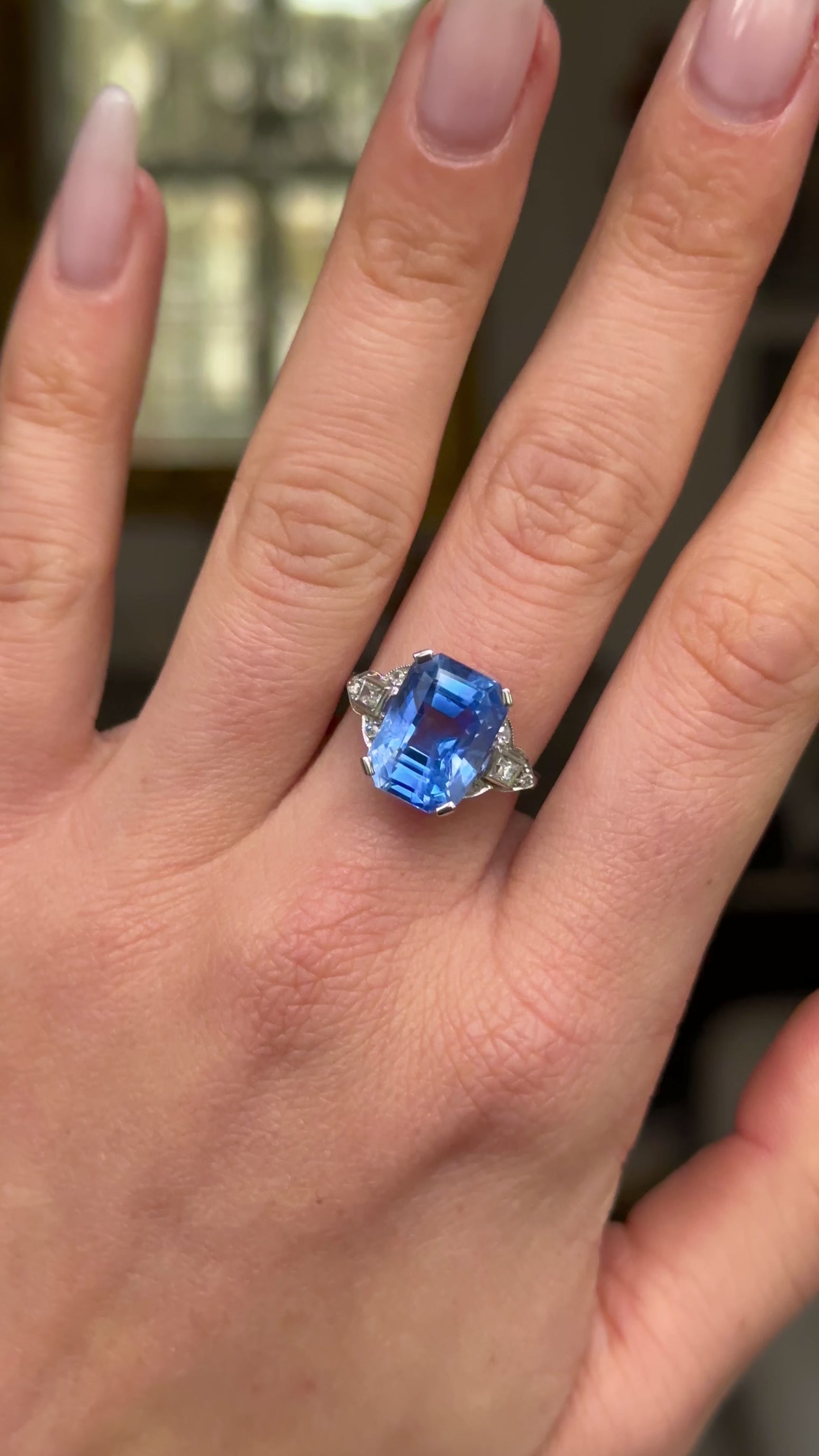 Art Deco sapphire and diamond ring worn on hand and moved around to give perspective.