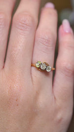 A video of an Antique Art Nouveau diamond three-stone ring worn on the hand