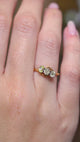 A video of an Antique Art Nouveau diamond three-stone ring worn on the hand
