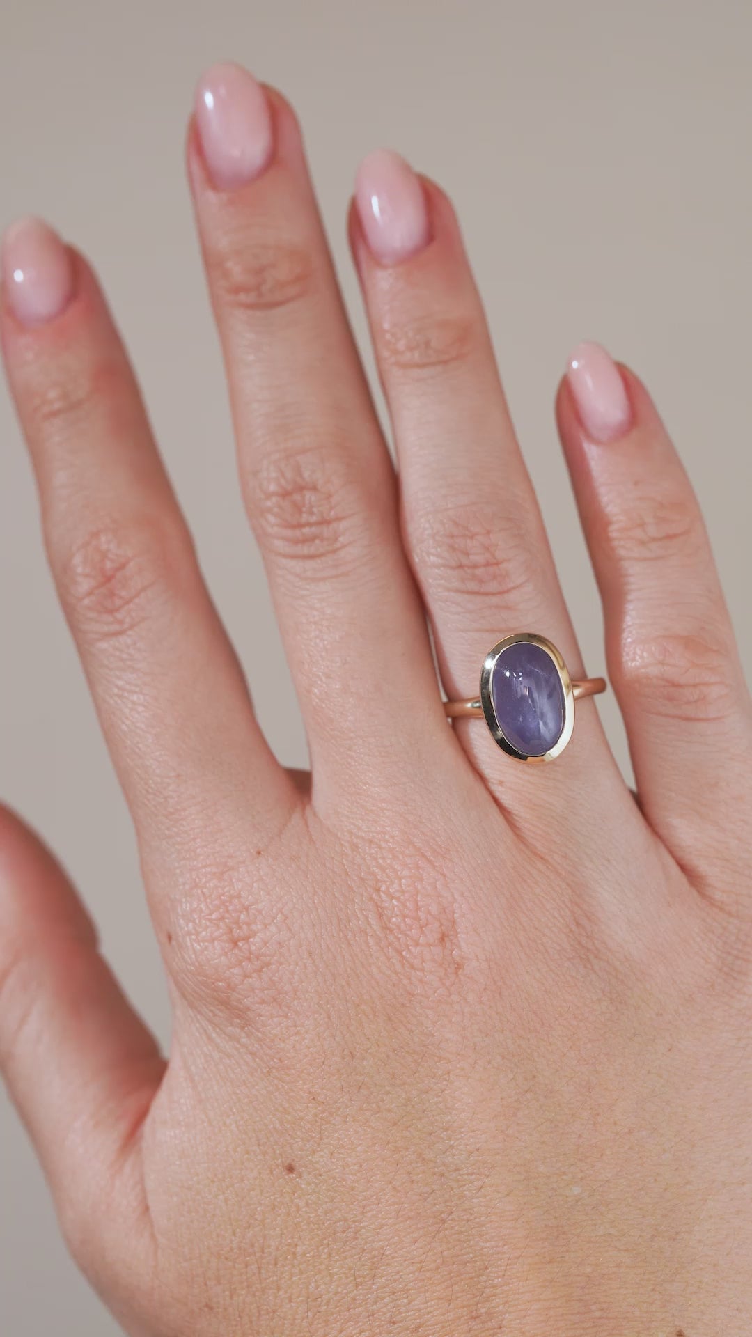A video of the antique-inspired sapphire ring being worn, capturing the gemstone's shifting blue and violet tones.
