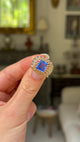 Vintage ceylon sapphire and diamond ring held in fingers and moved around to give perspective. 