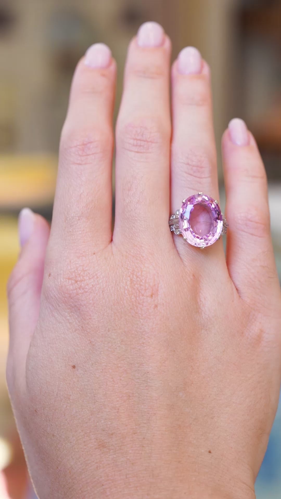 Art Deco pink topaz and diamond cocktail ring worn on hand showing pink topaz sparkle and diamond detail in movement.