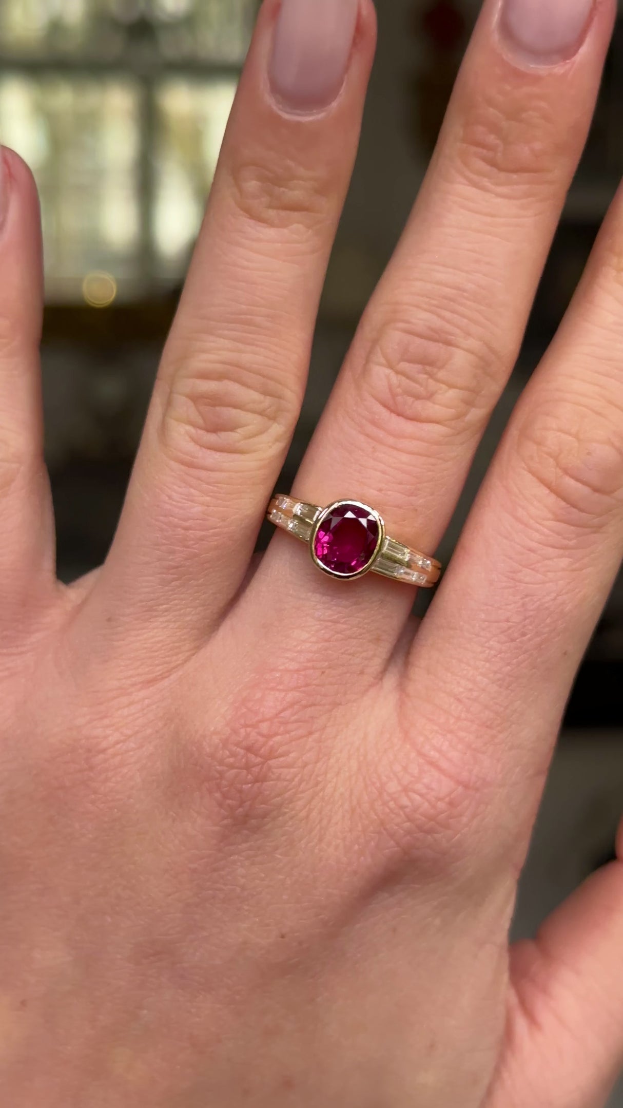 Art Deco ruby and diamond ring worn on hand and moved around to give perspective.