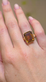 A video of a vintage Cartier smoky quartz cocktail ring worn on the hand.