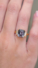 A video of a Blue spinel three-stone engagement ring shown at full scale on the hand.