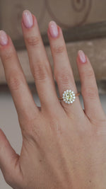 A video of a yellow diamond cluster engagement ring worn on a hand, showcasing its elegant proportions and design.