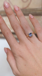 A video of the blue sapphire solitaire ring worn on a finger, capturing the gemstone's vibrant blue tones and sparkle.