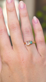 A video of a yellow gold Antique-inspired, colourless and blue Sapphire toi et moi two stone engagement ring worn on a hand that slowly turns.