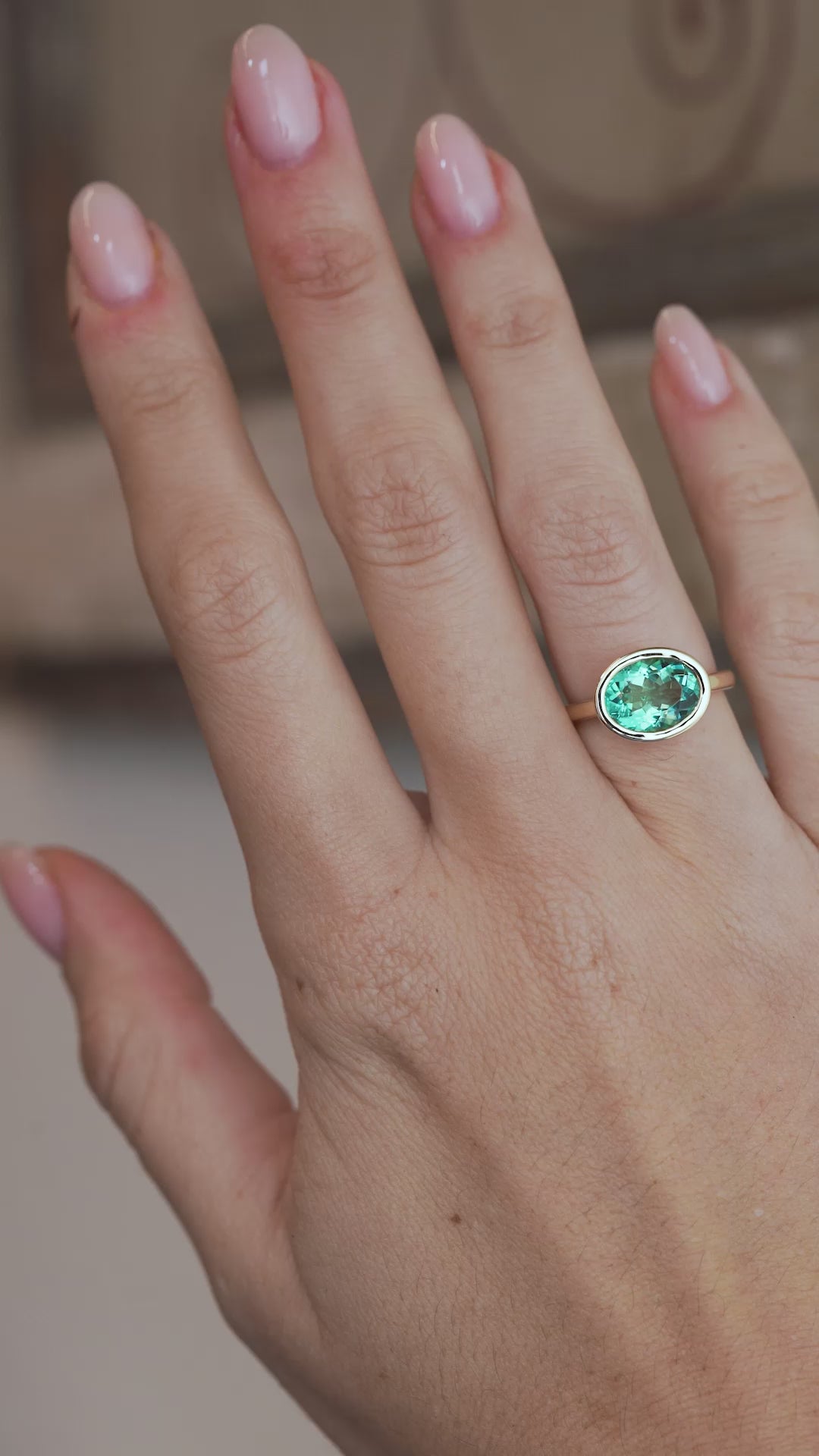 A video of the oval beryl ring worn on a finger, capturing the gemstone's beautiful sea-green tones and sparkle.