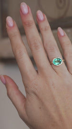 A video of the oval beryl ring worn on a finger, capturing the gemstone's beautiful sea-green tones and sparkle.