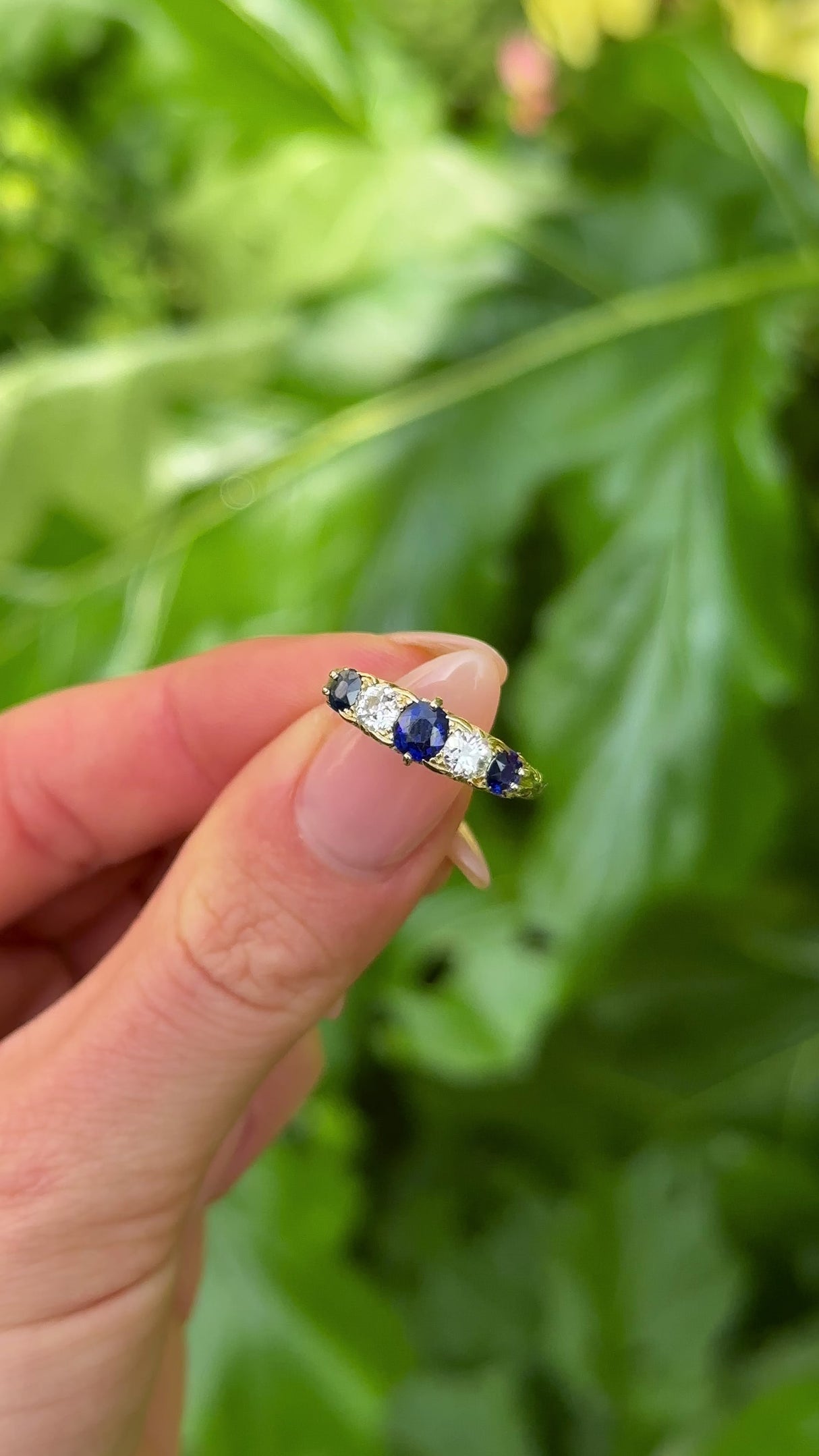 Antique, Edwardian Sapphire and Diamond Five-Stone Ring, 18ct Yellow Gold held in fingers.