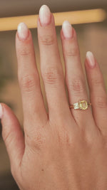 A hand wearing Antique-inspired, Diamond and yellow sapphire Toi et Moi engagement ring in a video turning it to show the scale 