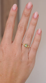 Video of the teal sapphire ring on the hand, capturing the gemstone’s green-blue tones and diamond sparkle.