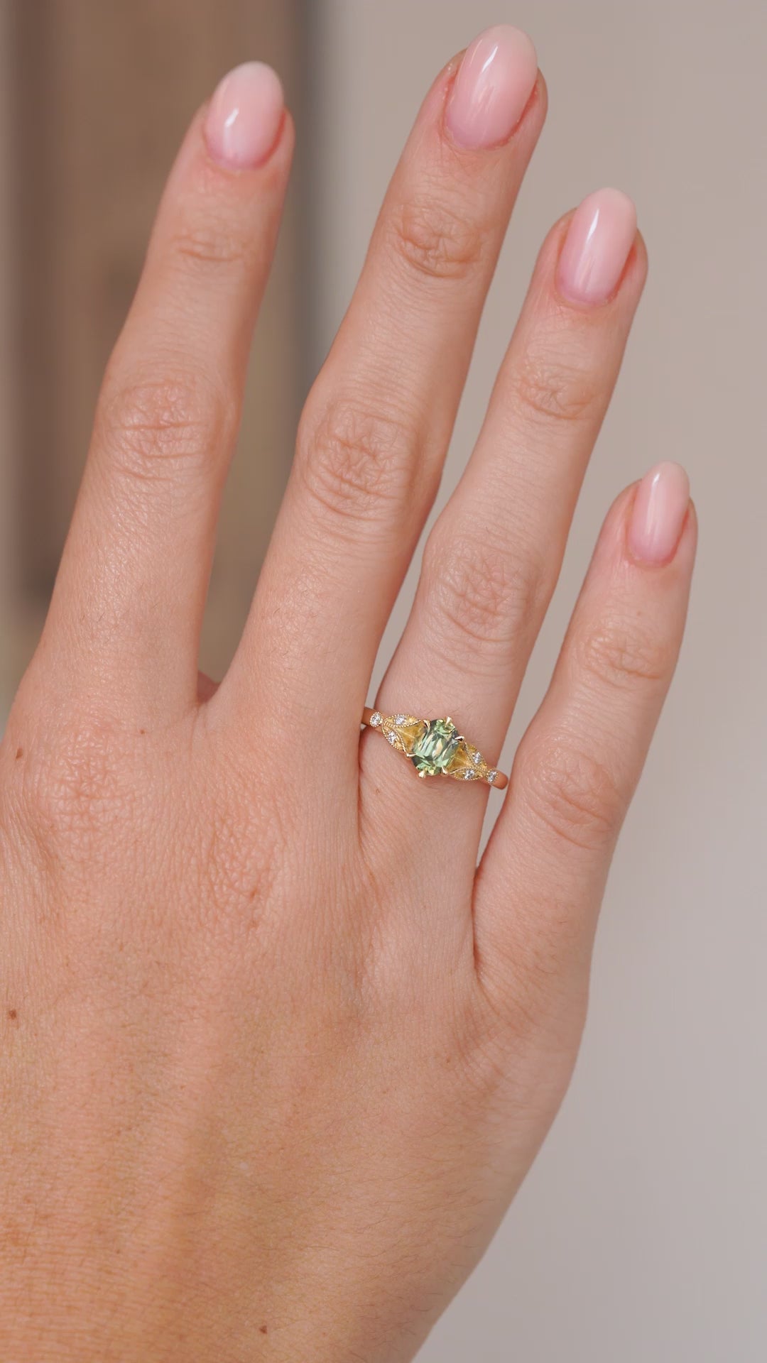 Video of the teal sapphire ring on the hand, capturing the gemstone’s green-blue tones and diamond sparkle.