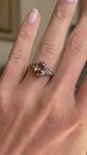Antique-inspired hazelnut-brown diamond and rose-cut diamond engagement ring featuring a hazelnut-brown diamond centre stone with rose-cut diamond accents, displayed on a hand.