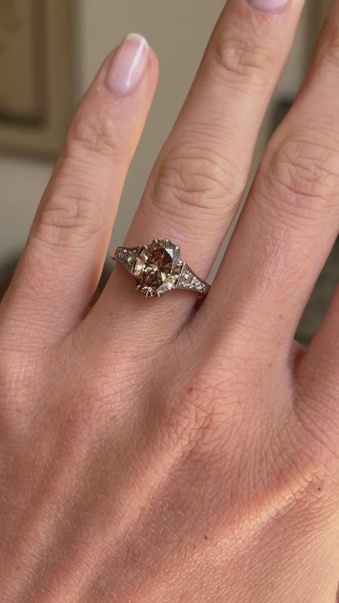 Antique-inspired hazelnut-brown diamond and rose-cut diamond engagement ring featuring a hazelnut-brown diamond centre stone with rose-cut diamond accents, displayed on a hand.