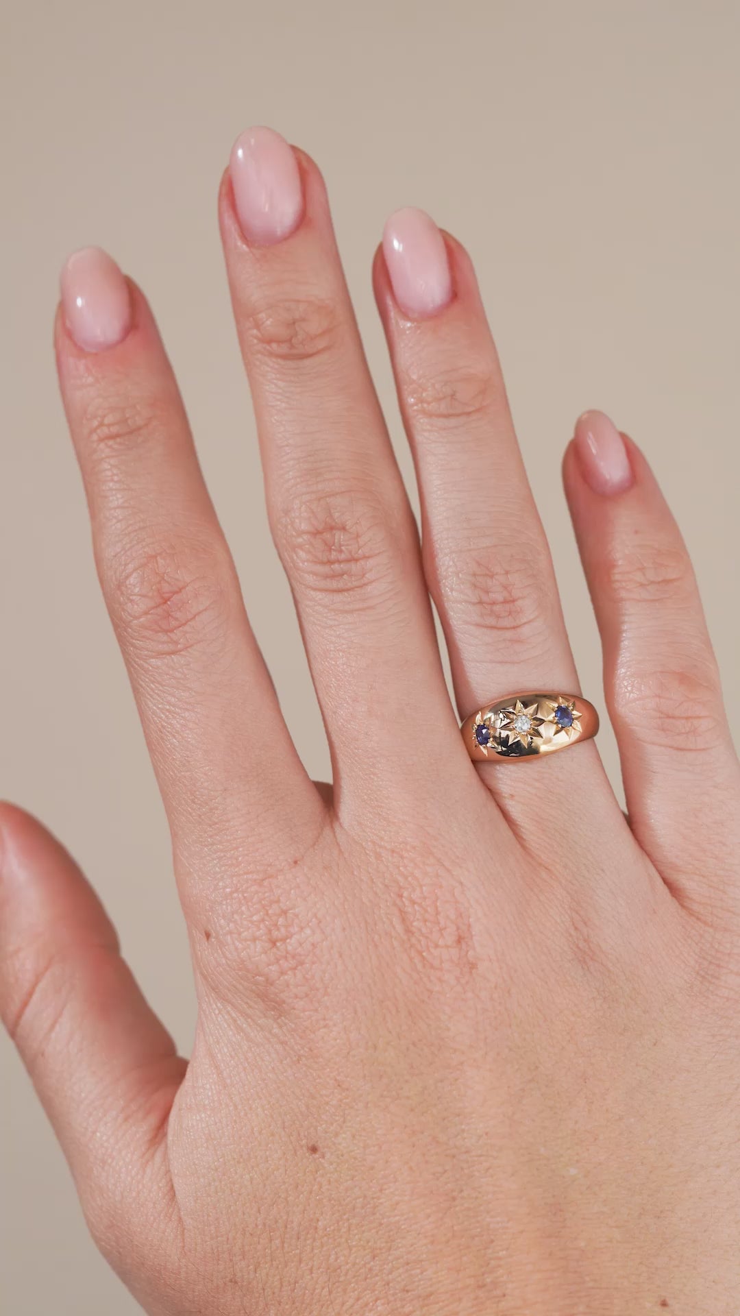 A video of the antique Edwardian ring being worn, highlighting the contrast between the blue sapphires, central diamond and warm gold.