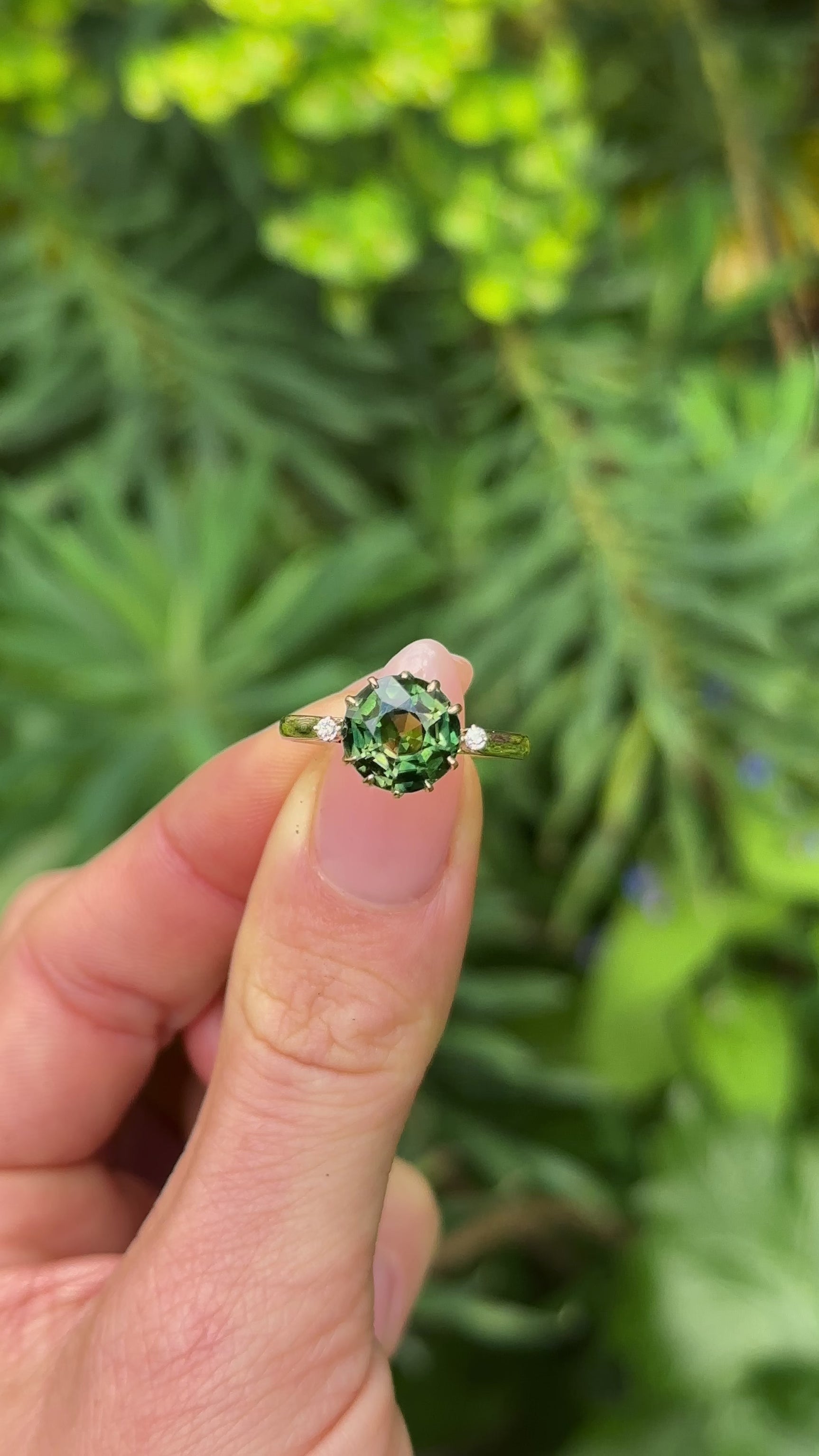 Antique, Edwardian Green Sapphire and Diamond Three-Stone Ring, 18ct Yellow Gold held in fingers.