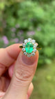 Vintage, Emerald and diamond cluster ring, 18ct yellow gold held in fingers