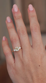A hand-model video showing the scale and sparkle of the three-stone ring.