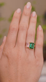 A video of Vintage-inspired, Green tourmaline and pink sapphire Toi et Moi engagement ring worn on the hand seen from a distance