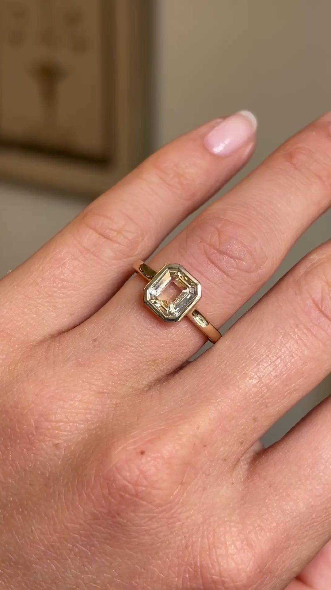 Video of an Antique-inspired Pale yellow sapphire solitaire engagement ring in yellow gold worn on a wedding finger.