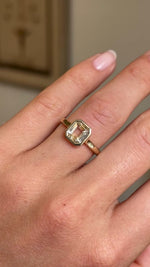 Video of an Antique-inspired Pale yellow sapphire solitaire engagement ring in yellow gold worn on a wedding finger.