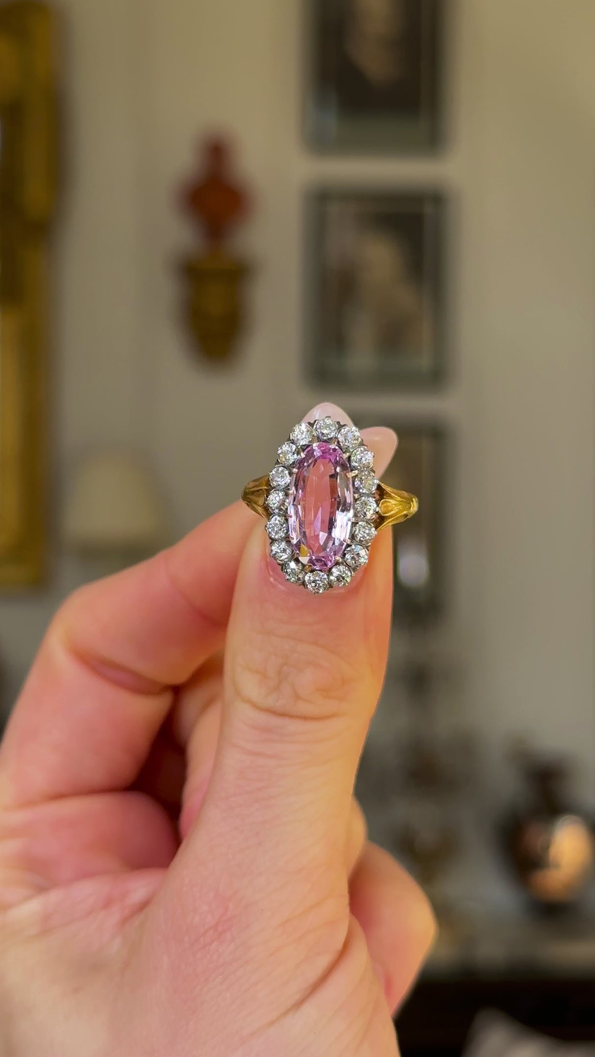 Antique, Belle Époque Pink Topaz and Diamond Cluster Ring, 18ct Yellow Gold held in fingers and rotated to give perspective.