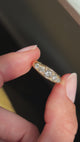 Antique Victorian old-mine cut diamond five-stone engagement ring featuring five graduated old-mine cut diamonds, held by hand for detailed viewing.