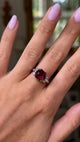 Vintage red garnet and diamond ring, worn on hand and moved around to give perspective.