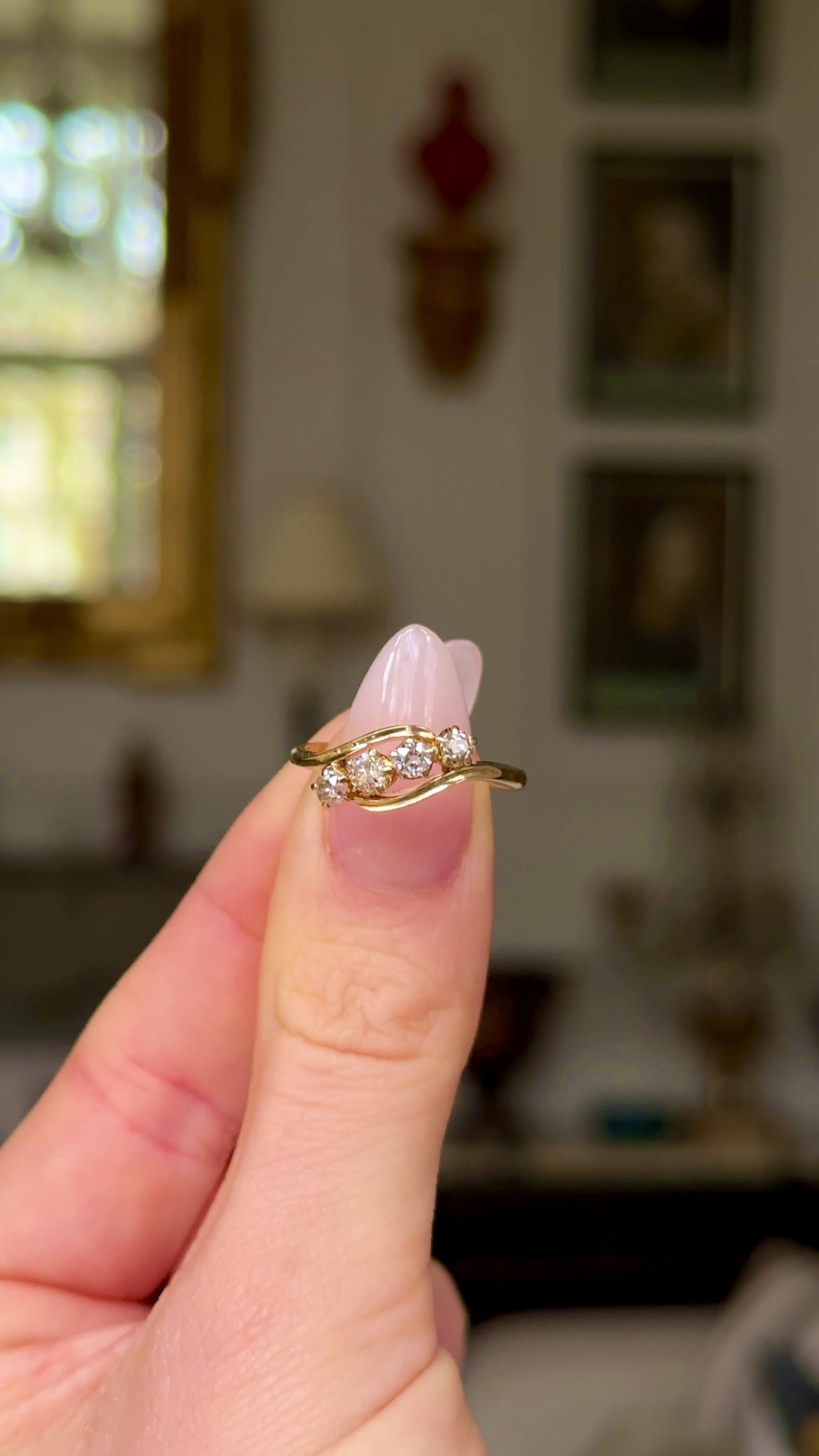 Antique four-stone diamond ring moved around to give perspective