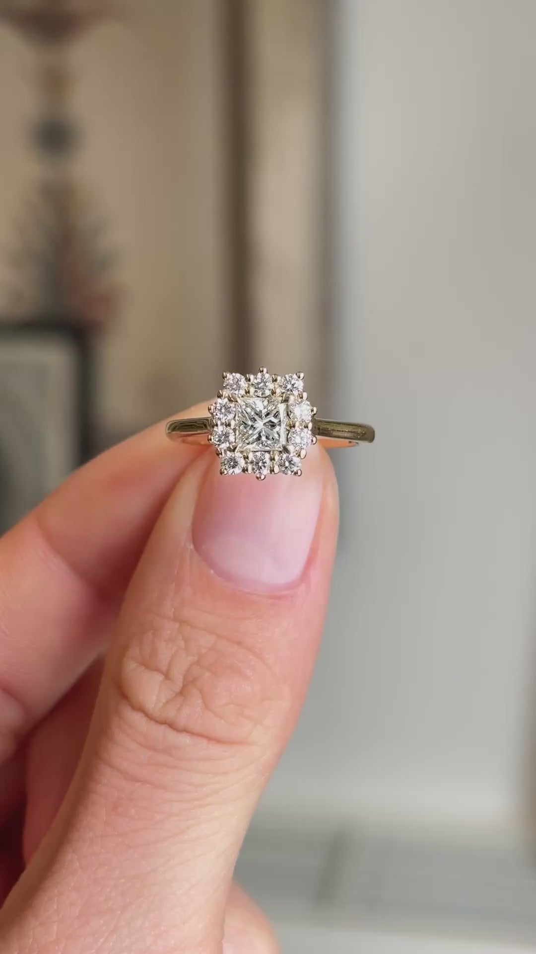 Close up video of an Antique-inspired, princess-cut diamond cluster engagement ring in gold, slowly rotated to see the different profiles