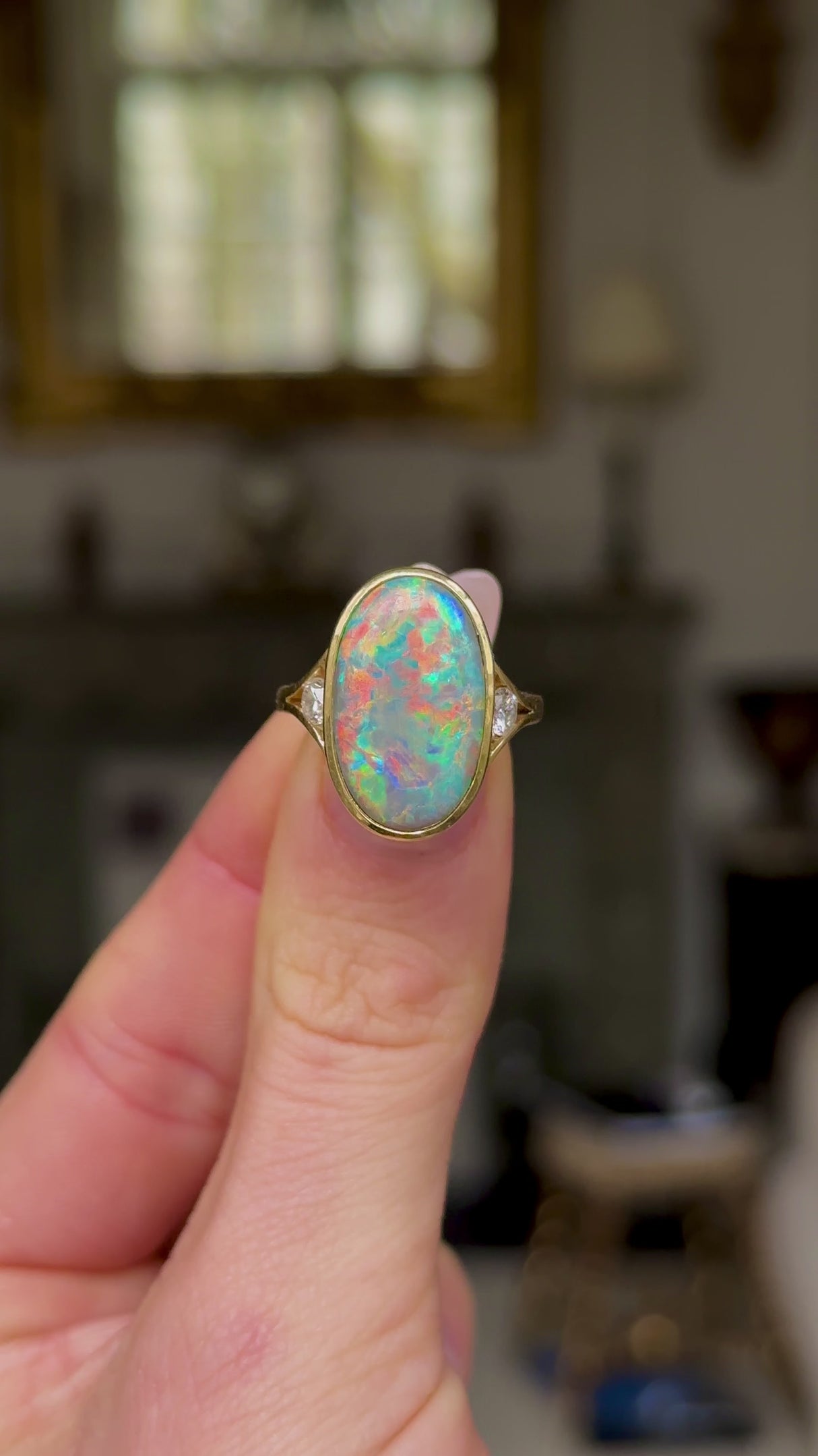 Contemporary, Black Opal and Diamond Cocktail Ring, held in fingers and moved around to give perspective.