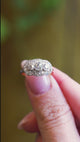 Old cut diamond cluster ring shown in close detail with layered diamond setting.