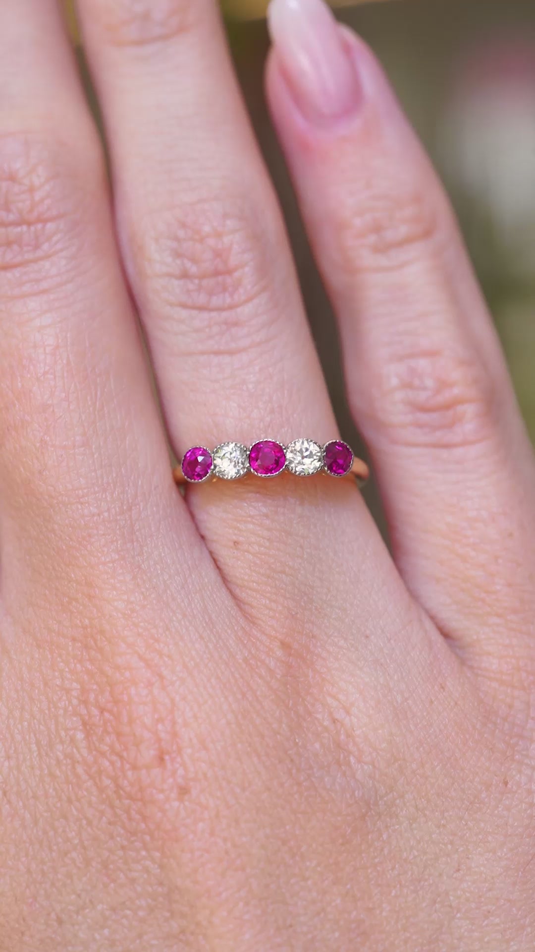 A video of an antique Edwardian ruby and old-cut diamond five-stone ring worn on the hand.