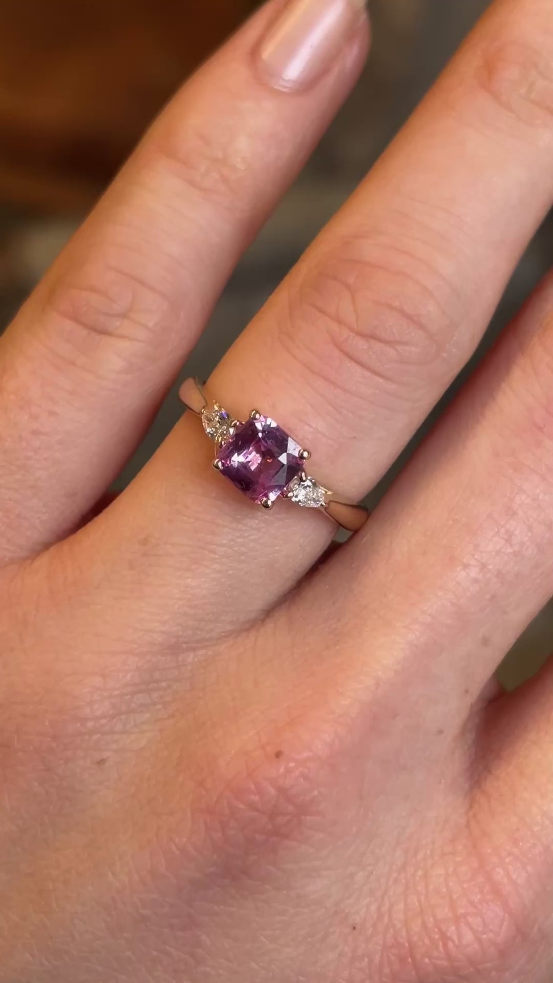 Pink sapphire and diamond three-stone engagement ring