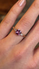 Pink sapphire and diamond three-stone engagement ring