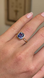 A video of a close-up of an Antique-inspired, vivid violet sapphire solitaire engagement ring set in yellow gold worn on a hand.