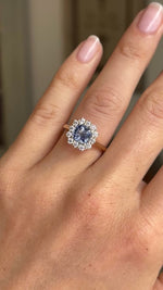 Video of an Antique-inspired, Cornflower-blue sapphire and diamond cluster engagement ring in yellow gold worn on a wedding finger