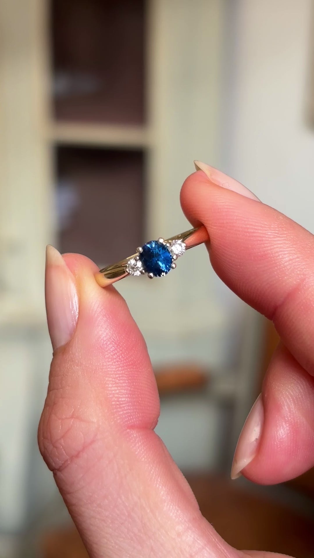 Blue sapphire and diamond three-stone engagement ring