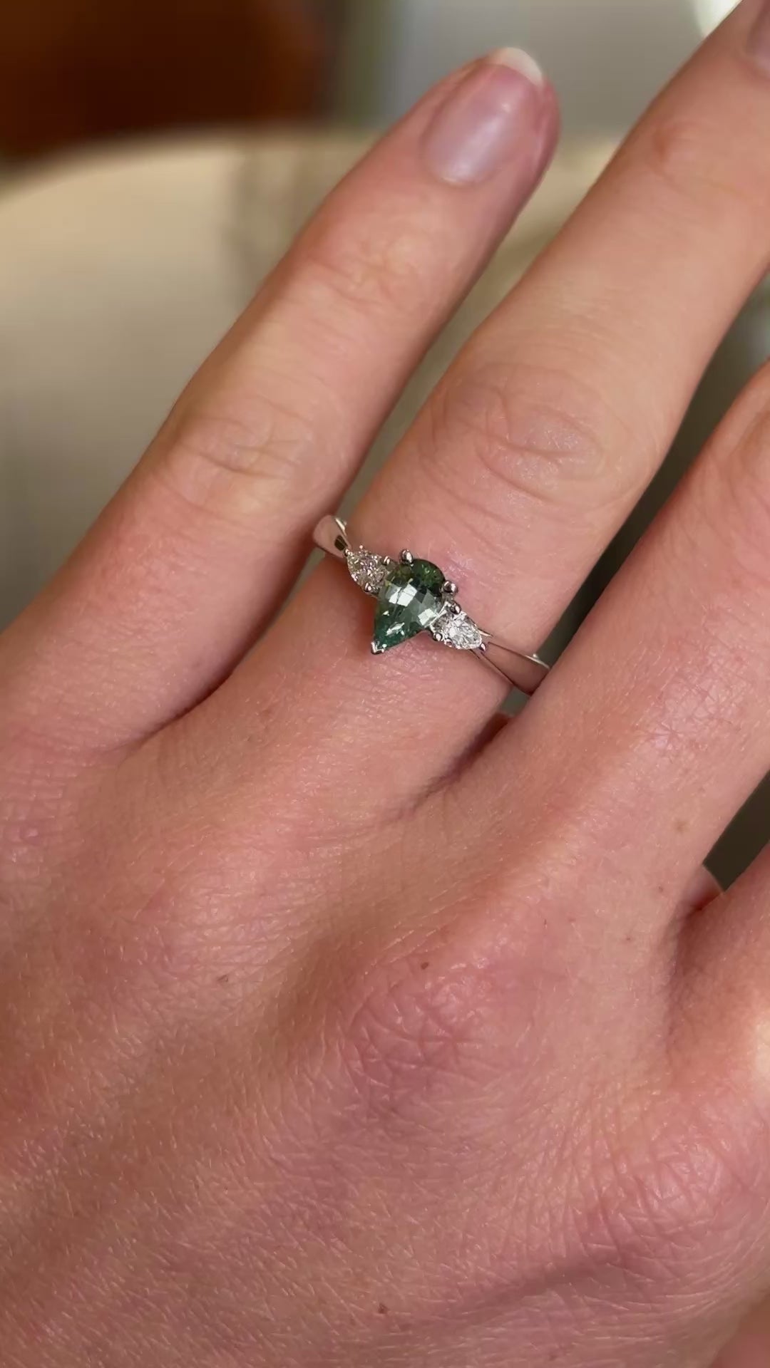 Pear-cut teal sapphire & diamond three-stone engagement ring