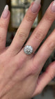 Art deco  diamond cluster ring worn on closed hand and moved around to give perspective.