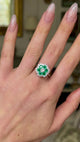 Vintage emerald and diamond cluster ring worn on hand, and moved around to give perspective.