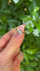 Antique, Edwardian Three Stone Diamond Engagement Ring, 18ct Yellow Gold & Platinum held in fingers.