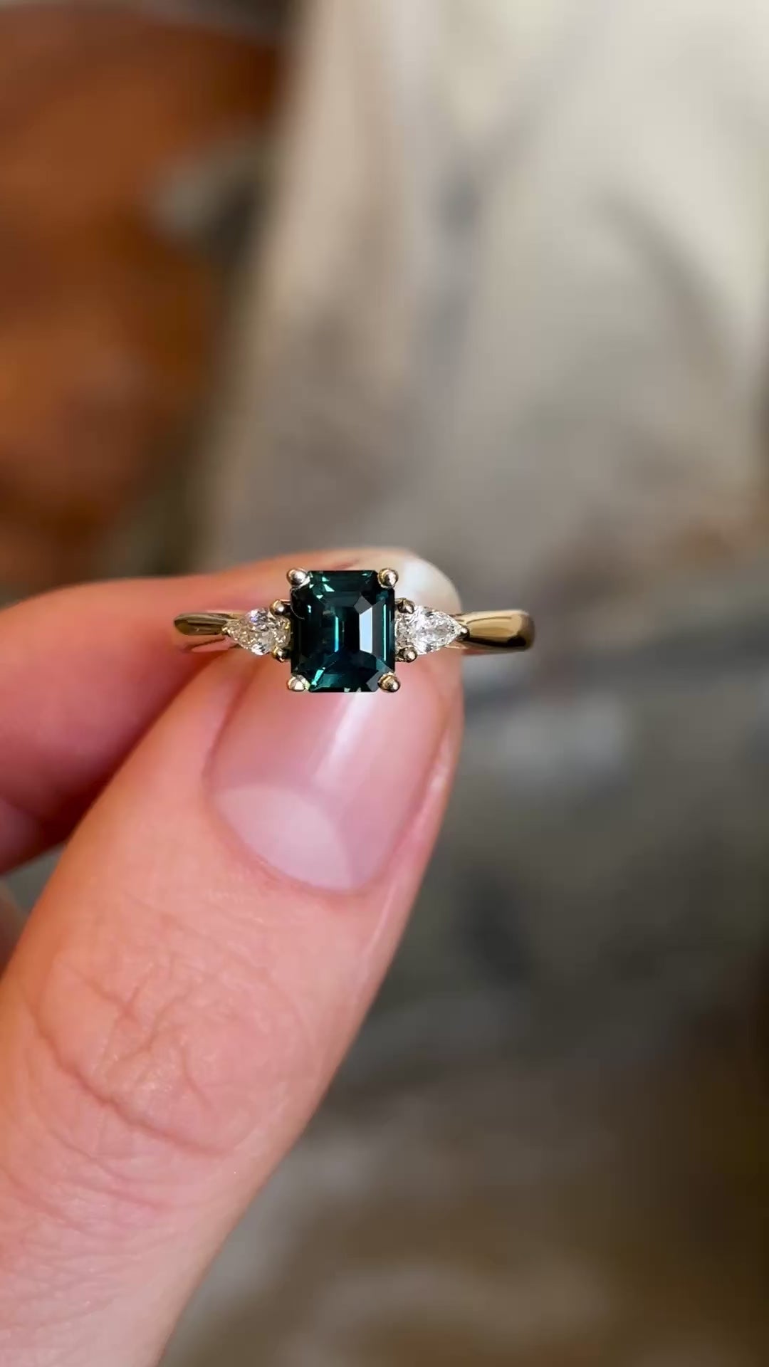 Green sapphire and diamond three-stone engagement ring rotated to show details 