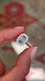 Video of an Antique-inspired, blue sapphire and diamond cluster engagement ring in yellow gold, rotated to show all the angles of the ring