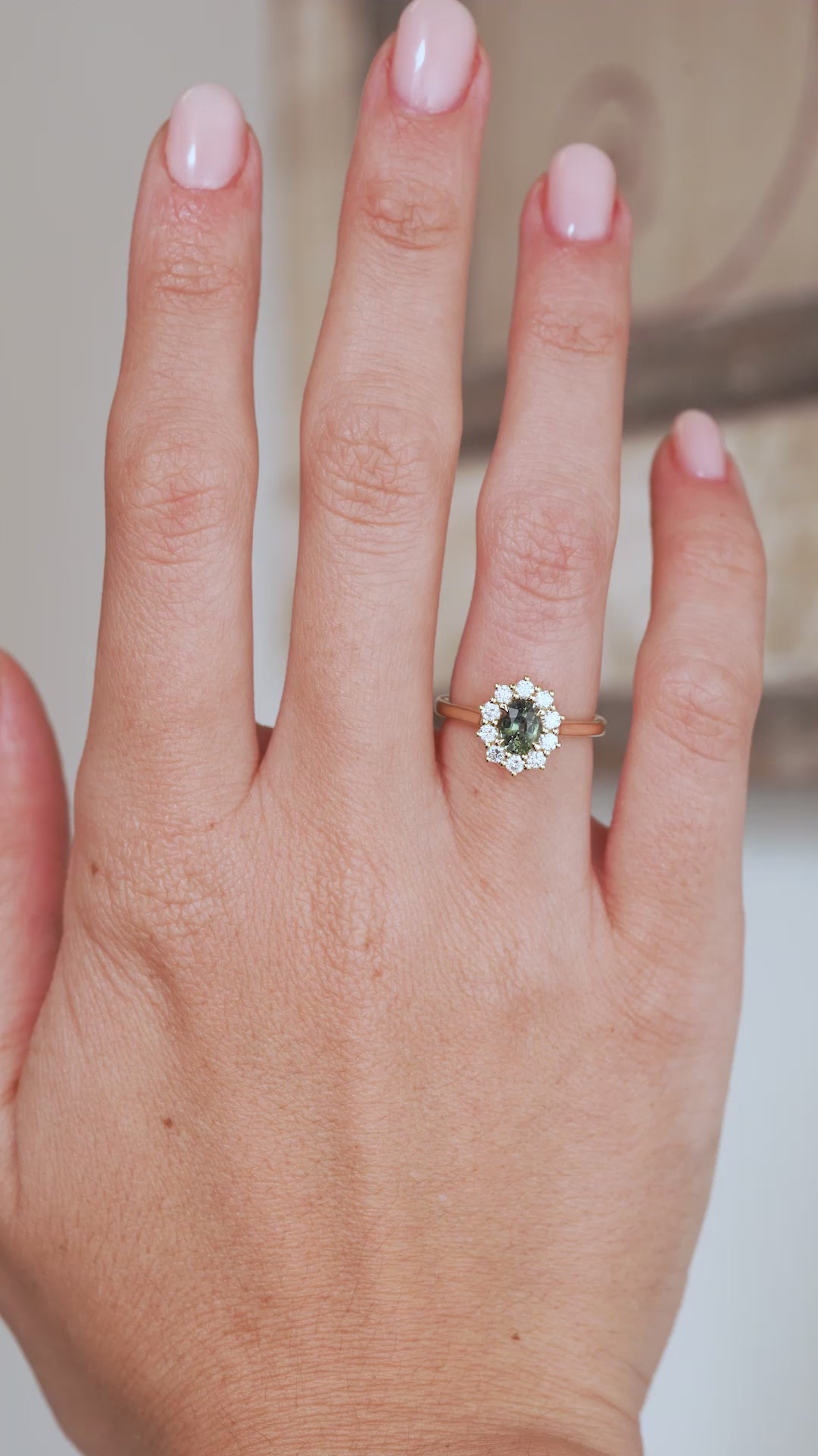 Video of the green sapphire and diamond engagement ring being worn, capturing its sparkle, scale and elegant yellow gold proportions.