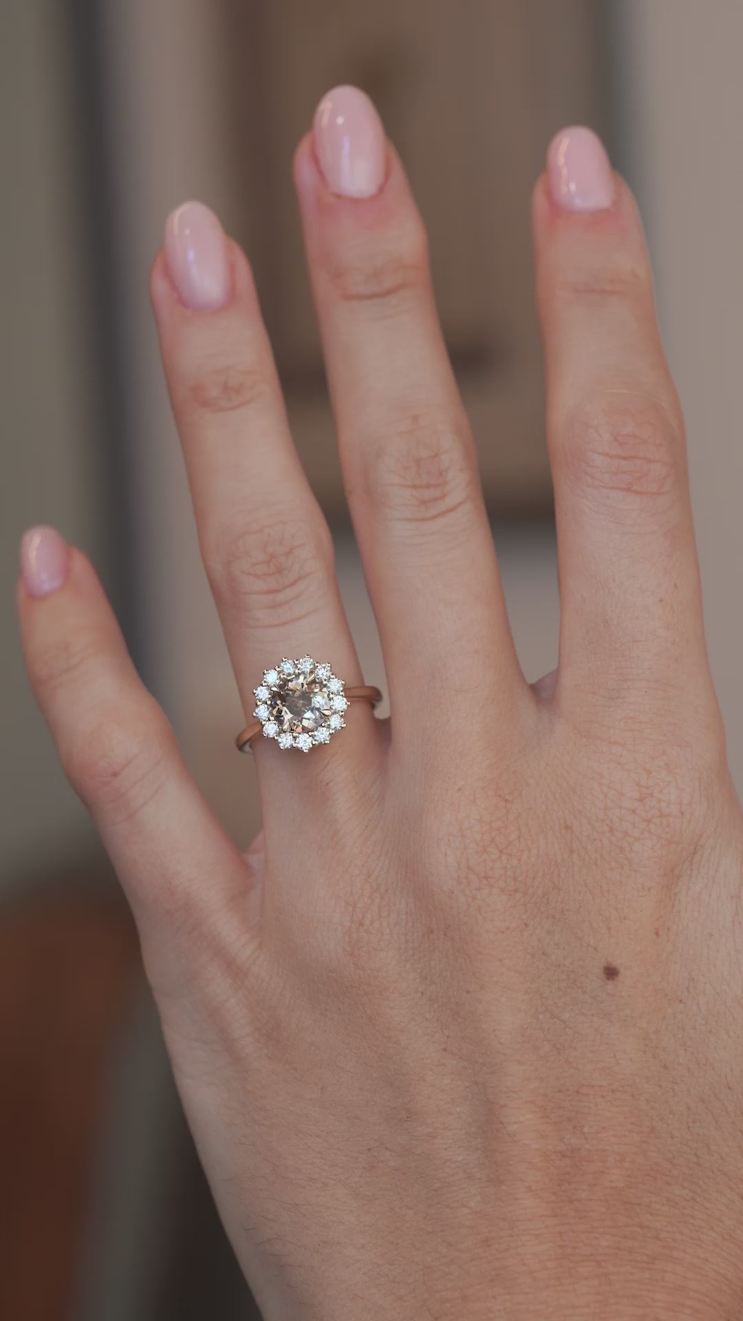A video of the smoky cognac diamond cluster ring worn on a finger, showcasing its sparkle and appearance when worn.