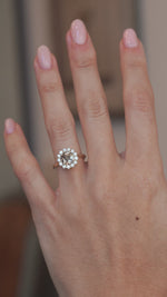 A video of the smoky cognac diamond cluster ring worn on a finger, showcasing its sparkle and appearance when worn.