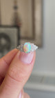 Close-up video of an antique Art Deco opal and diamond cluster ring, highlighting the iridescent opal centre stone and surrounding diamonds.